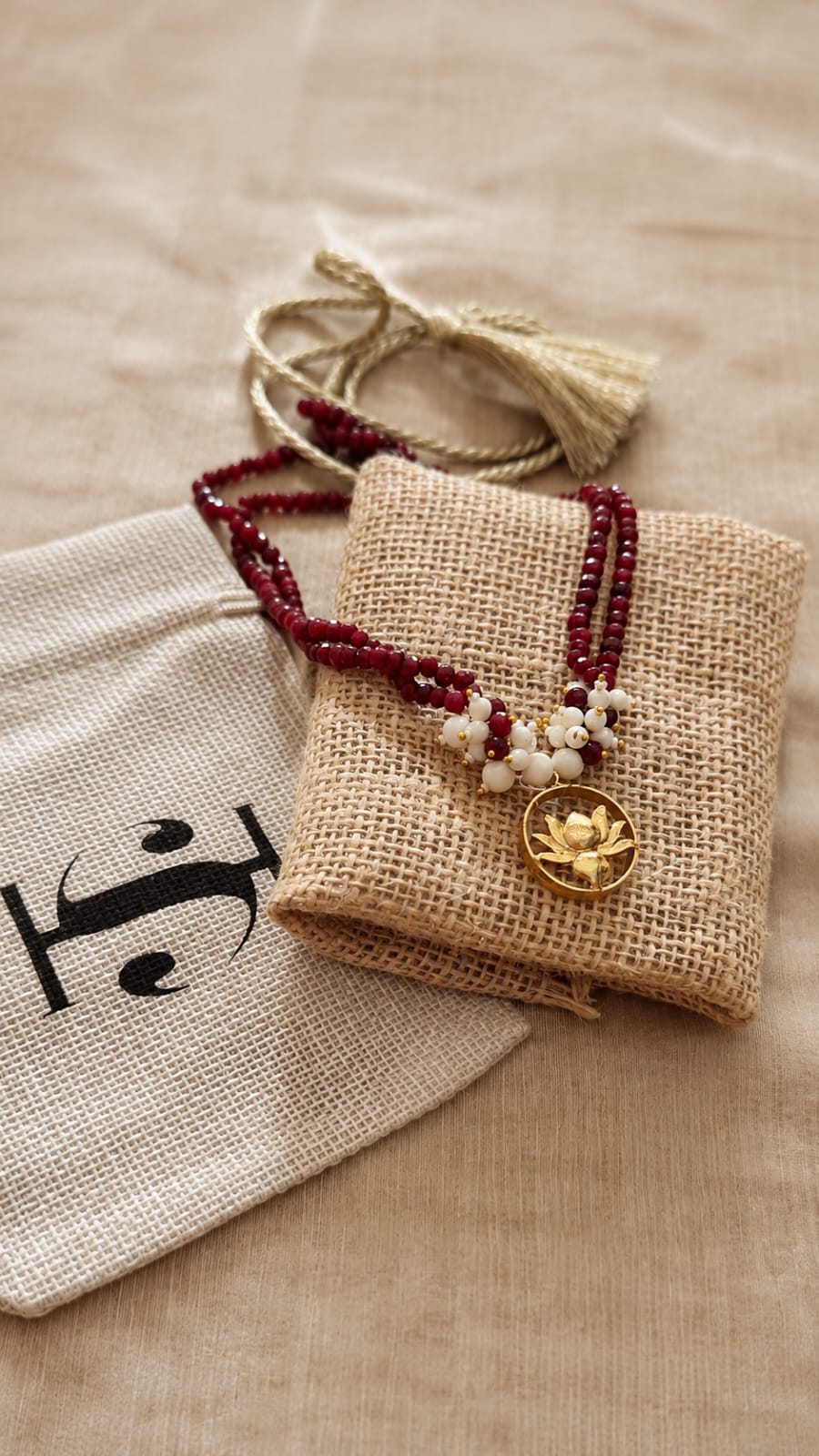 Ruby-Red Strands with the Lotus Pendant