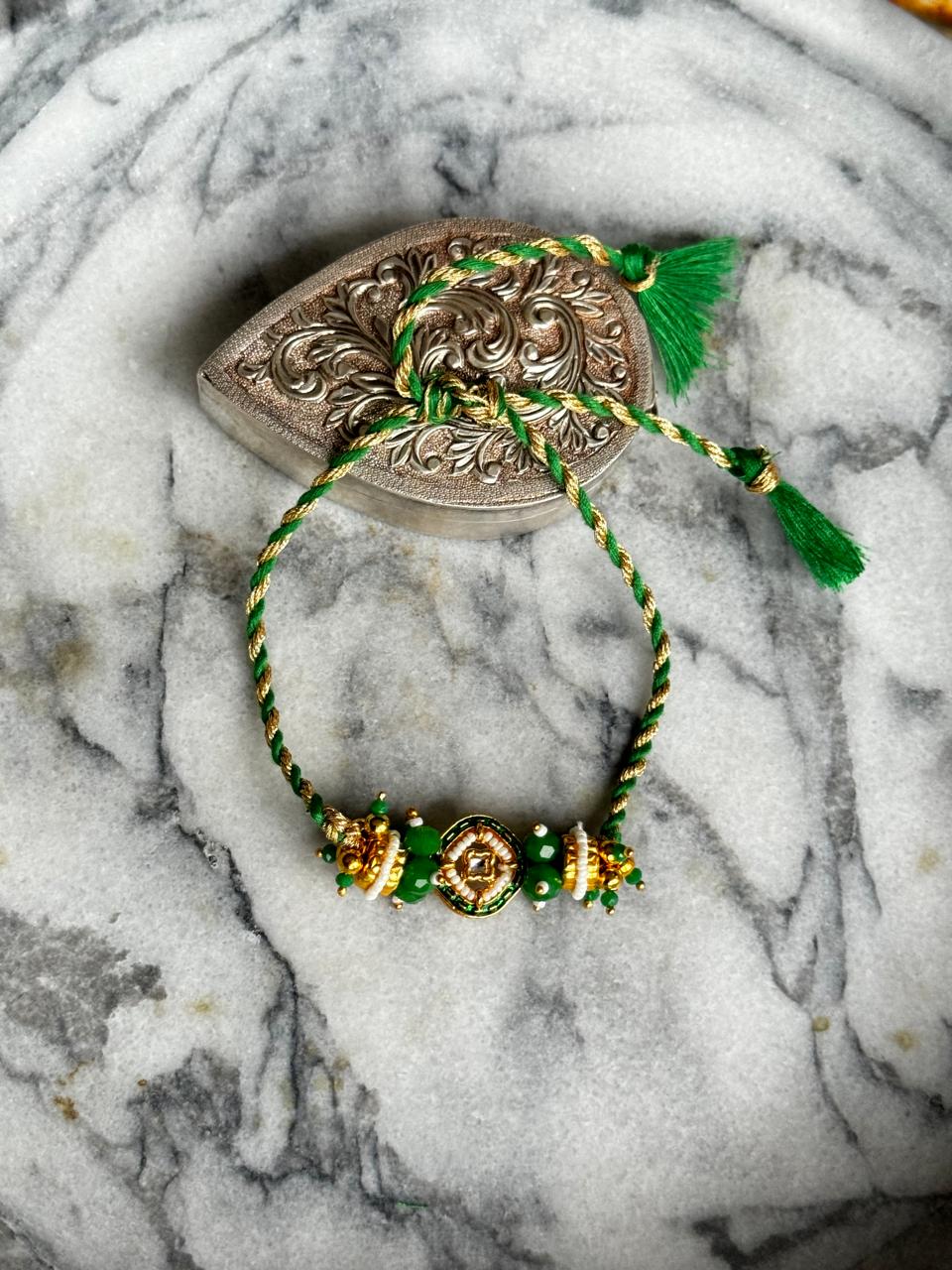 Green stone Rakhi | 18kt Gold Plated